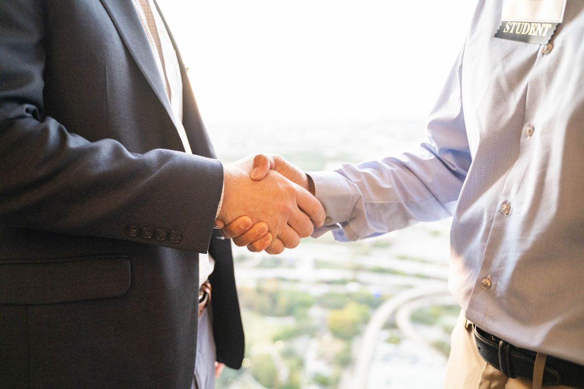 Photo: Employer representative shakes the hand of a Bauer College student at a recent career recruiting event.